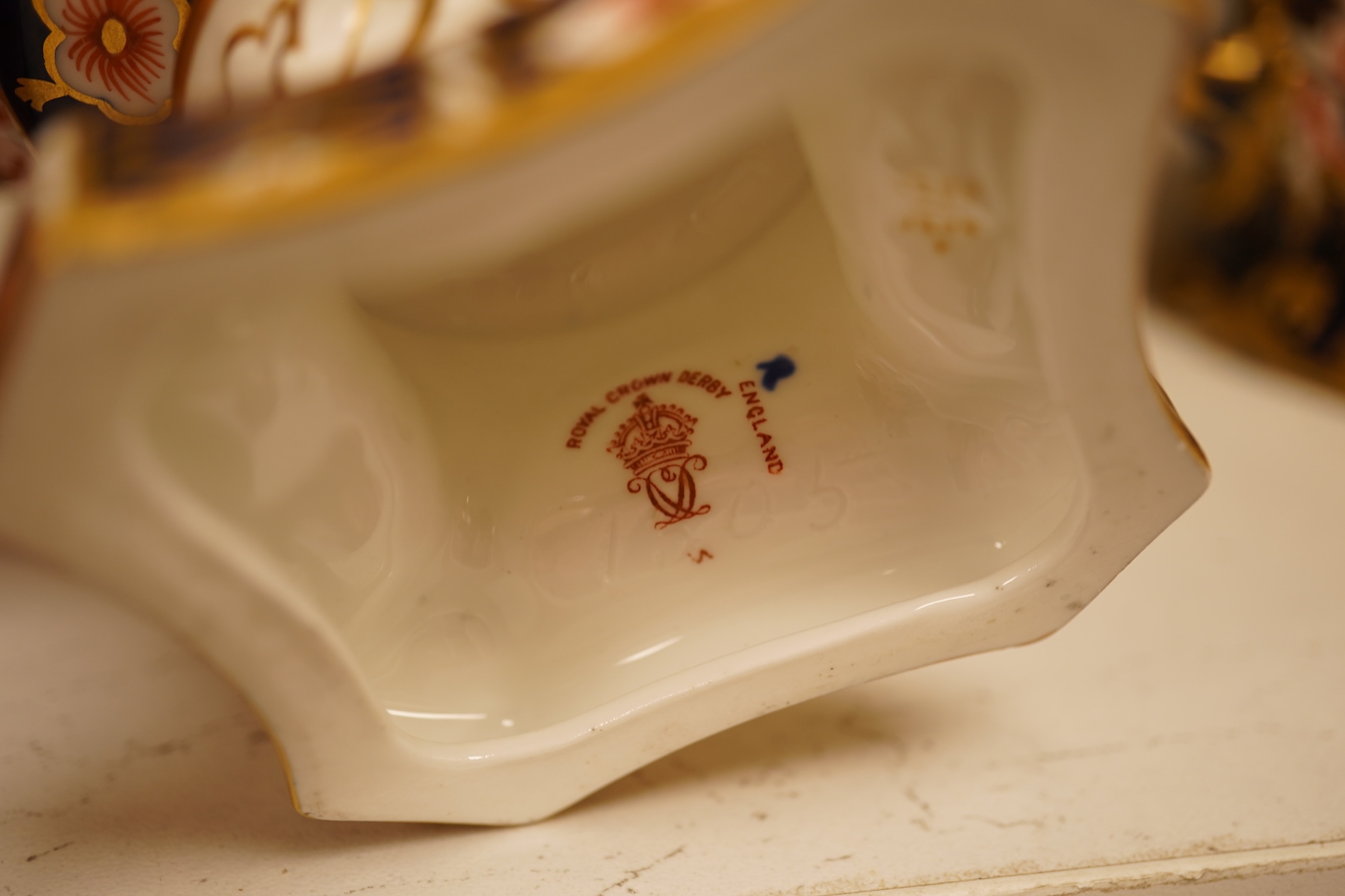 A collection of Royal Crown Derby, to include a two handled bowl, a fluted pedestal vase, saucer with landscape central cartouche etc (5). Vase 19cm high.